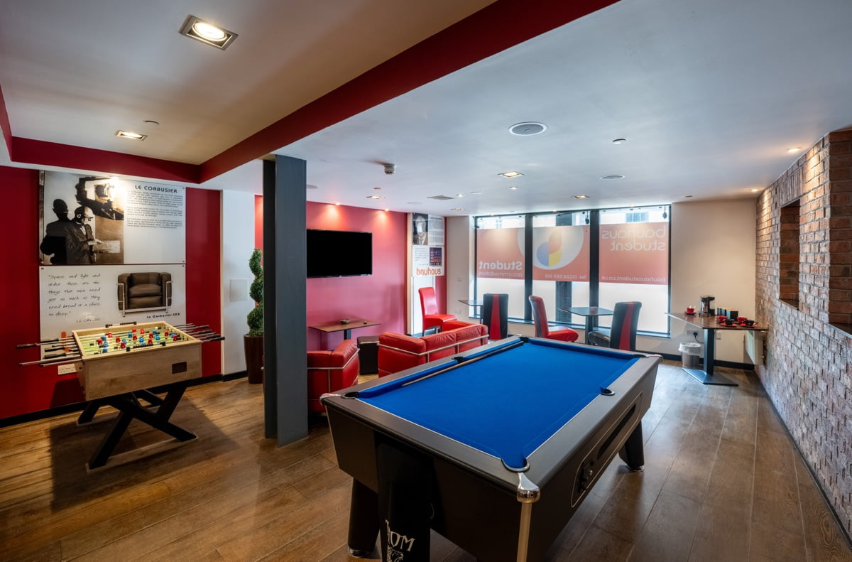 A shot of one of the communal areas in langstan place bauhaus student accommodation, showing a pool table, table football, seating areas and coffee machine